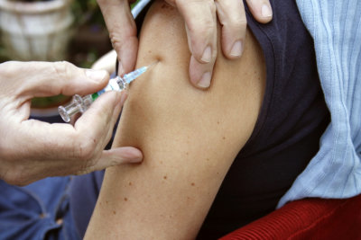 nurse applying vaccine